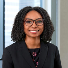 A professional headshot of Celina Andrade in front of windows.