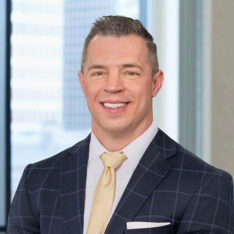 A professional headshot of Anthony Gatto standing in front of windows.