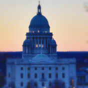 Rhode Island state house with the sun set in the background.