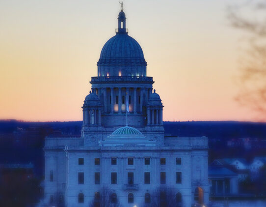 Rhode Island state house with the sun set in the background.