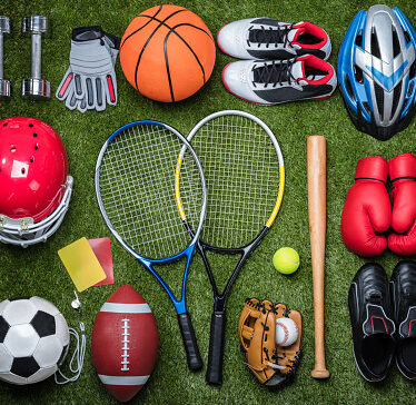 High angle view of various sports equipment on grass.