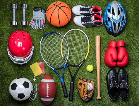 High angle view of various sports equipment on grass.