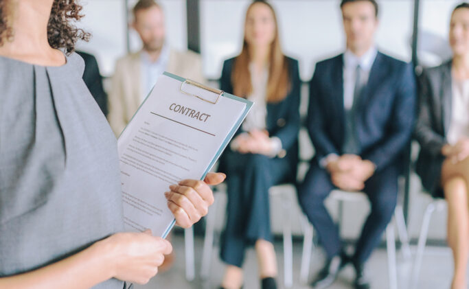 Woman Holding Contract on Clipboard