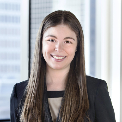 A professional headshot of Kristen Souza in front of windows.