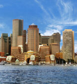 The Boston skyline with the Boston Harbor in the foreground.