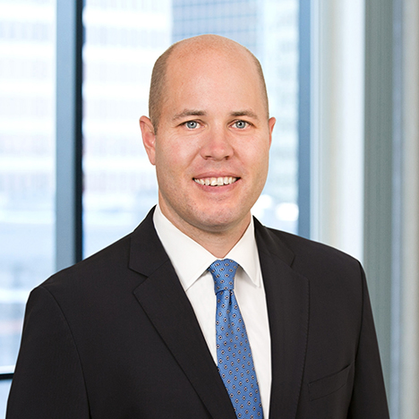 A professional headshot of Michael Brown in front of windows.