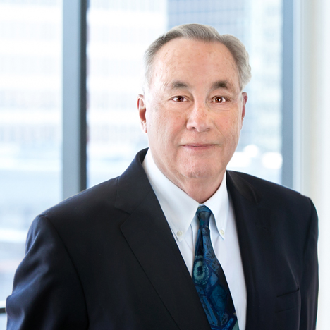 A professional headshot of Joseph DeAngelis in front of windows.