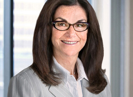 A professional headshot of Susan DeBlasio in front of windows.