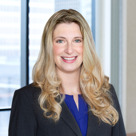 A professional headshot of Kelly Kincaid in front of windows.