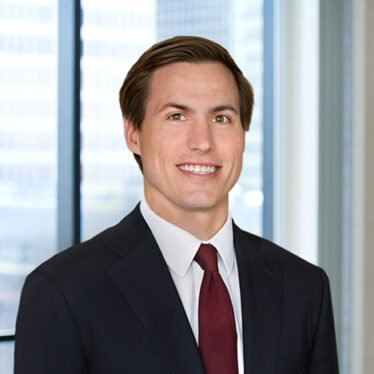 A professional headshot of Stephen Nelson in front of windows.