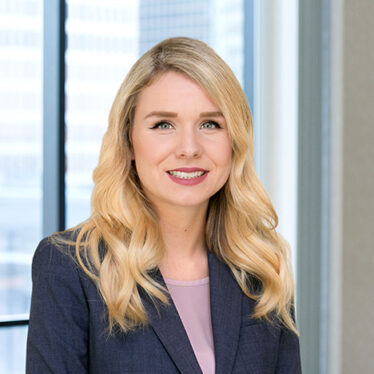 A professional headshot of Siobhan Surette in front of windows.