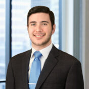 A professional headshot of Michael D'Ippolito III in front of windows.