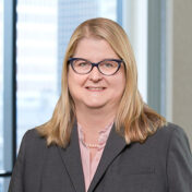 A professional headshot of Kathryn Windsor in front of windows.