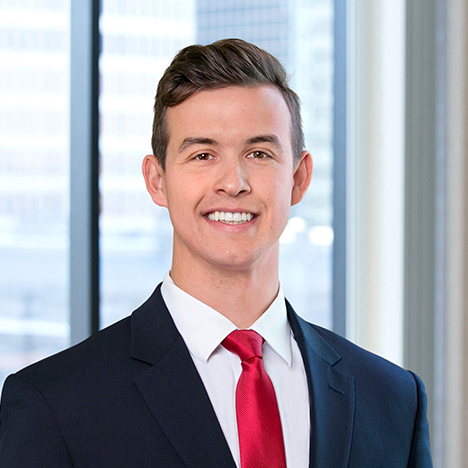 A professional headshot of Nickolas Arnold in front of windows.