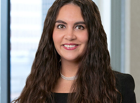 A professional headshot of Erin Hockensmith in front of windows.