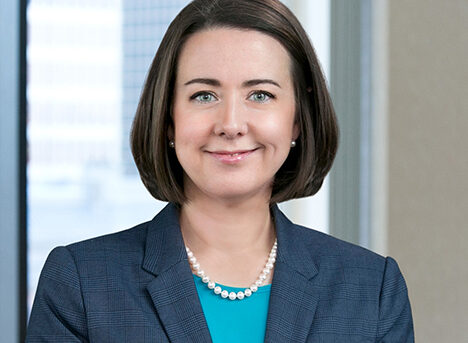 A professional headshot of Kristin Matsko in front of windows.