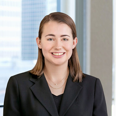 A professional headshot of Margaret Lynch in front of windows.